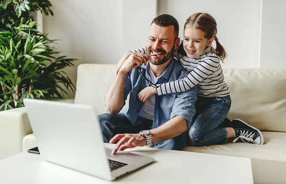 Happy family using a laptop